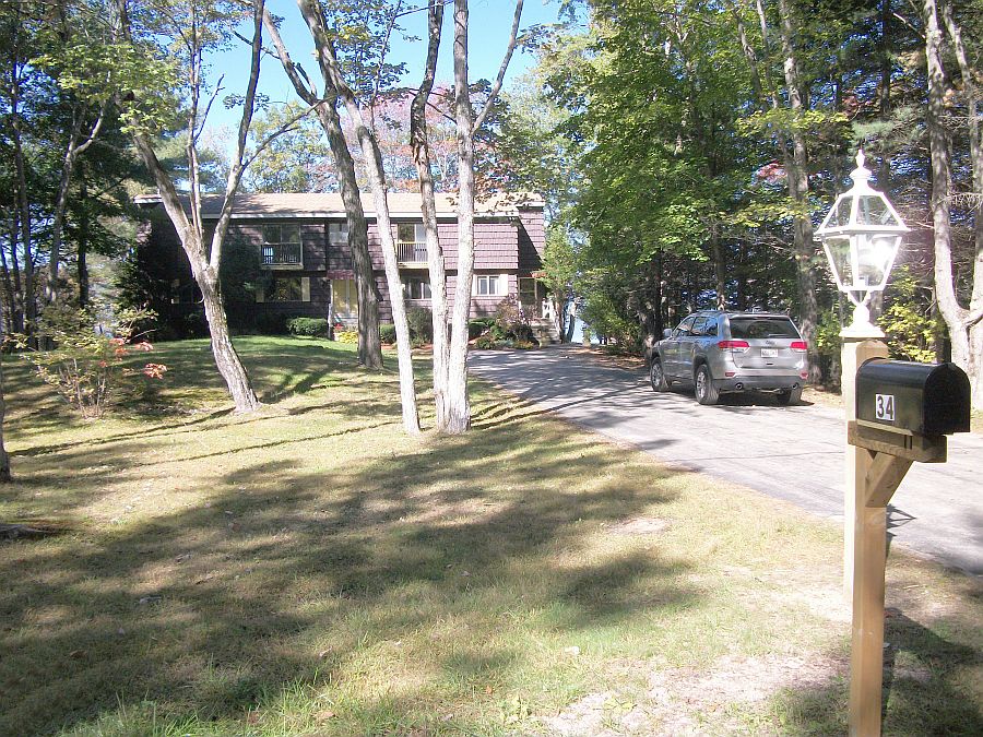 Driveway to front provides convenient access and ample parking in serene setting